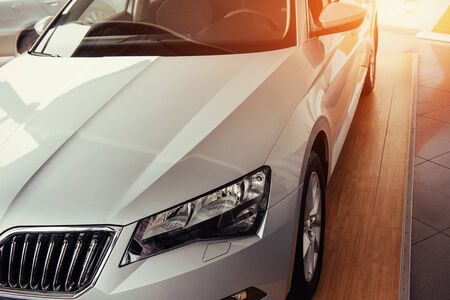 The headlights and the hood of a black sports carの写真素材