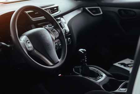 Modern car interior dashboard and steering wheelの写真素材