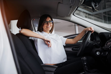 portrait of young beautiful woman sitting in the car