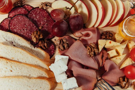 large wooden table meat, bread and vegetablesの写真素材