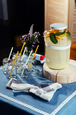 party drink station with small bottles and homemade lemonade