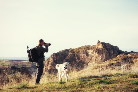 Photographer sandstone cliff and observing the natural landscapeの写真素材