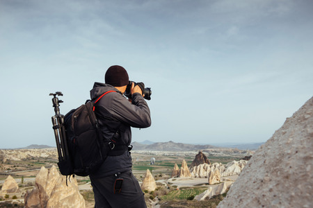 Photographer sandstone cliff and observing the natural landscapeの写真素材