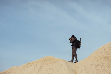 Photographer sandstone cliff and observing the natural landscapeの写真素材