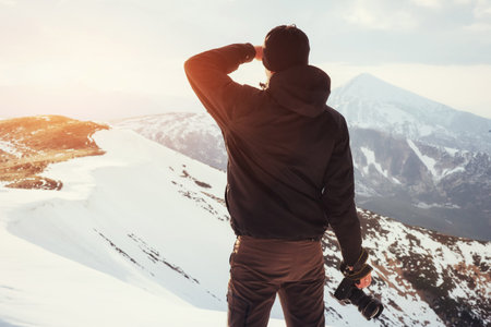 tourist looks at the landscape. Photographer on top of mountain. Spring landscape. Carpathians Ukraine Europeの写真素材