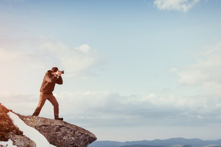 tourist looks at the landscape. Photographer on top of mountain. Spring landscape. Carpathians Ukraine Europeの写真素材