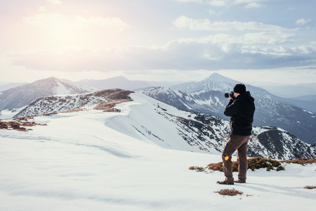tourist looks at the landscape. Photographer on top of mountain. Spring landscape. Carpathians Ukraine Europeの写真素材