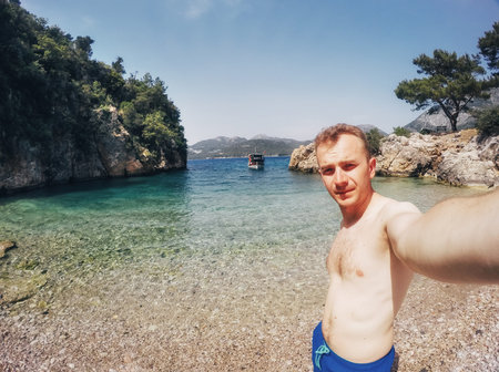 Tourist photographed against the backdrop of the sea. Scenic view of boats in the sea. Cappadocia. Turkey.の写真素材