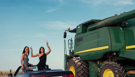 Girls posing for the camera in a black convertibleの写真素材