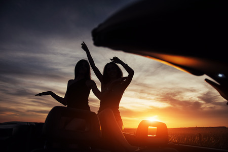 Young two women at a photo shoot. Girls gladly posingの写真素材