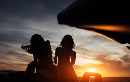 Young two women at a photo shoot. Girls gladly posingの写真素材