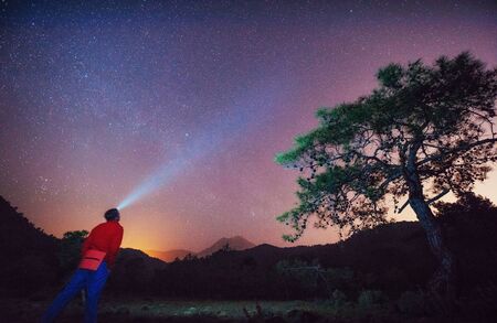 person of the world looking at the starry skyの写真素材