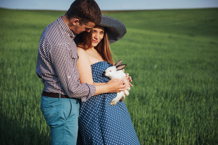 pregnant woman with her husband and rabbitの写真素材
