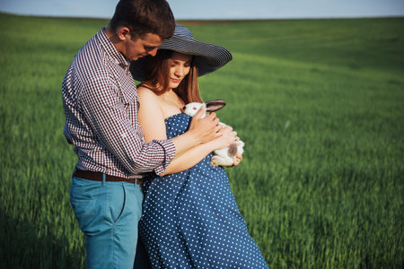 pregnant woman with her husband and rabbitの写真素材