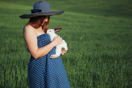 young pregnant woman in a field of wheatの写真素材