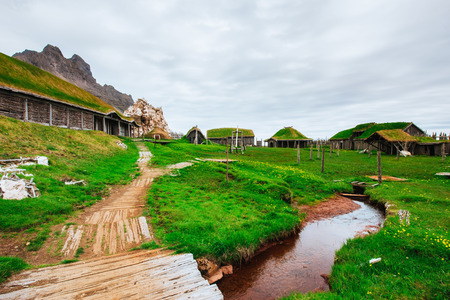 Traditional Viking village. Wooden houses near the mountain firsの写真素材