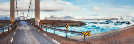 Bridge over a channel connecting Jokulsarlon Lagoon and Atlanticの写真素材