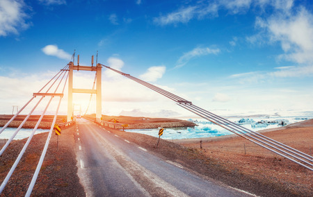 Bridge over a channel connecting Jokulsarlon Lagoon and Atlanticの写真素材