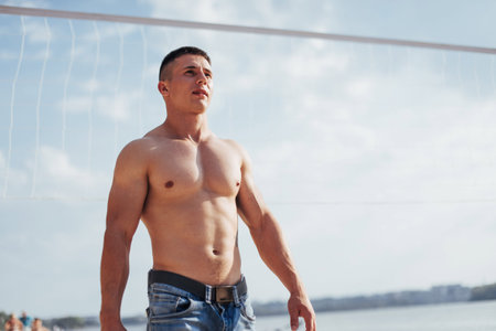 Beautiful athletic bodybuilder guy, carries out exercises with dの写真素材
