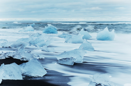 Glacier on black volcanic beach, Iceland.の写真素材