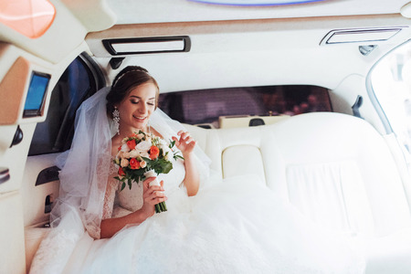 Portrait of a beautiful young bride in the carの写真素材