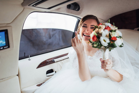 Portrait of a beautiful young bride in the carの写真素材