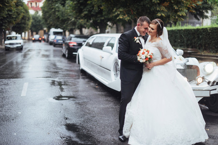 Happy young couple near the car on the roadの写真素材