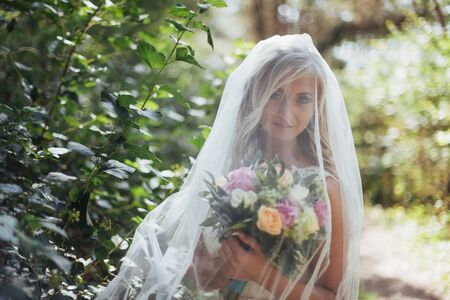 Portrait of a happy bride posing with veilの写真素材