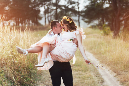 Happy young couple in a pine forest in summerの写真素材