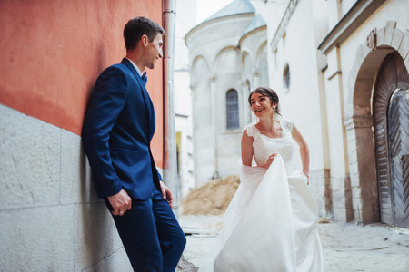 Wedding portrait of a happy couple. Stand and kissingの写真素材
