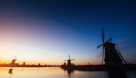 Colorful spring sunset traditional Dutch windmills canal in Rottの写真素材