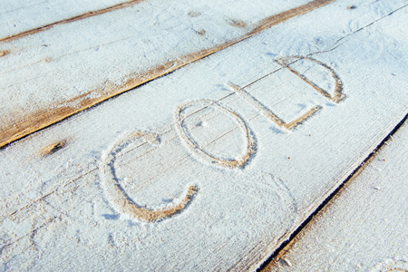 Writing on the snow. Wooden texture.の写真素材