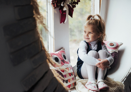 girl sitting by the windowの写真素材