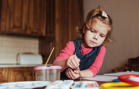 Cute little girl, adorable preschooler painting with watercolorsの写真素材