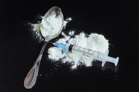 drug use, addiction and substance abuse concept - close up of spoon  syringe with crack cocaine  doseの写真素材