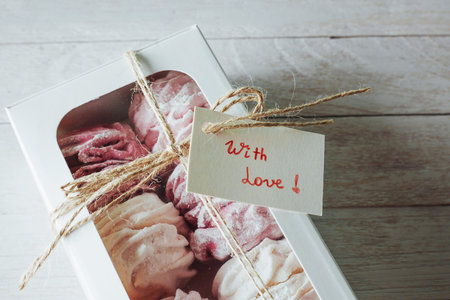 marshmallow in a box on  white wooden background. Delicious swe