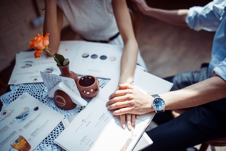 Romantic couple in love bonding in cafeの写真素材