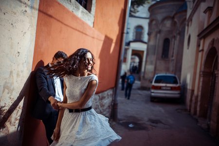 Young couple in love, hugging in the old part of townの写真素材
