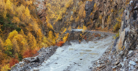 Fantastic golden autumn landscape between the rocky mountains in Georgia. Stone road. Europe