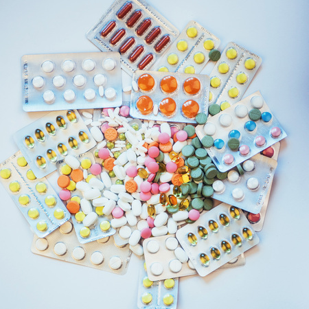 Pills of different colors lie on the surface in a sealed packageの写真素材