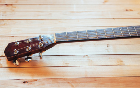 close up neck acoustic classical guitar on a light wooden background.の写真素材