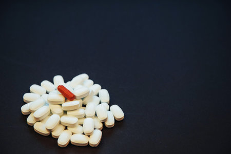 Medical colorful pills, capsules or supplements for the treatment and health care on a black...