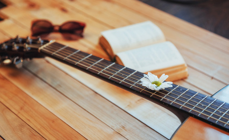 Close up classical guitar head with glasses and book.の写真素材