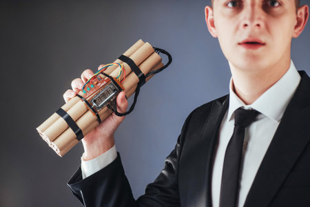 Man terrorist in a black suit with explosives and detonators.