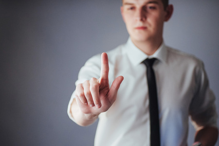 Businessman hand pointing on empty space on black background in the studioの写真素材