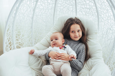 Child in soft warm pajama playing in bed. In good light studio