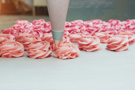 Homemade marshmallows pink on a white parchment.の写真素材