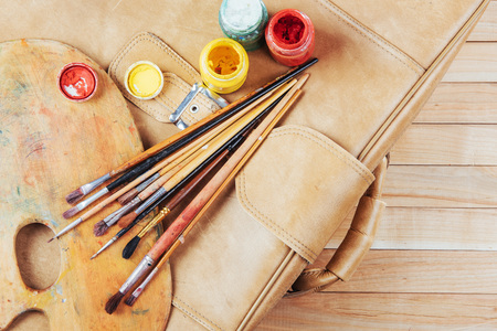 Box of watercolor paints, art brushes on canvas.の写真素材