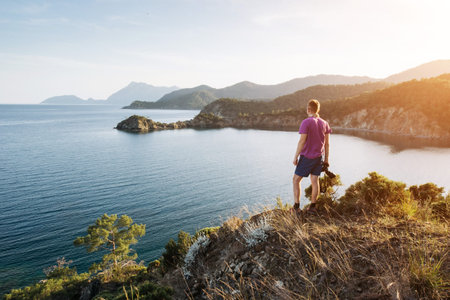 Tourist admiring the blue Mediterranean sea on the Turkish coast in the evening