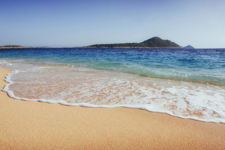 Fantastic views of the sea coast with yellow sand and blue water.